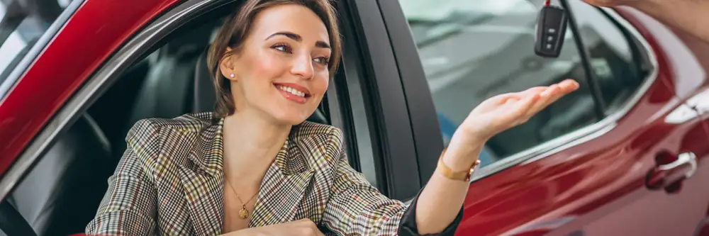 Customer receiving car keys at a rental counter