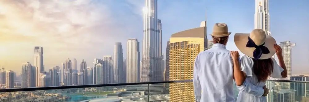 Couple on a balcony overlooking Dubai and the Burj Khalifa